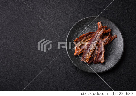 Dried salted fish as snacks or jerky, seafood as slices. Dried seafood snacks Dried salted fish as snacks or jerky, seafood as slices. Dried seafood snacks 131221680