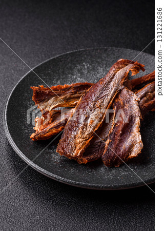 Dried salted fish as snacks or jerky, seafood as slices. Dried seafood snacks Dried salted fish as snacks or jerky, seafood as slices. Dried seafood snacks 131221686