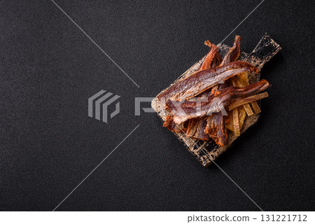 Dried salted fish as snacks or jerky, seafood as slices. Dried seafood snacks Dried salted fish as snacks or jerky, seafood as slices. Dried seafood snacks 131221712