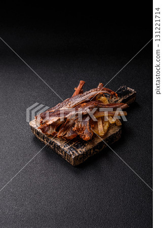 Dried salted fish as snacks or jerky, seafood as slices. Dried seafood snacks 131221714
