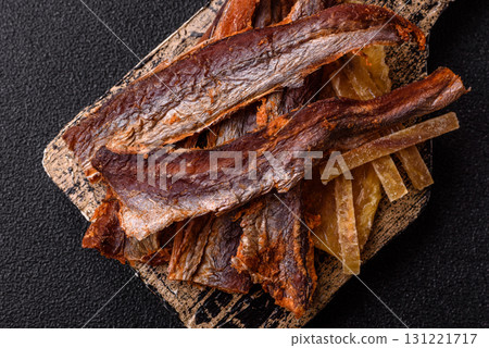 Dried salted fish as snacks or jerky, seafood as slices. Dried seafood snacks Dried salted fish as snacks or jerky, seafood as slices. Dried seafood snacks 131221717
