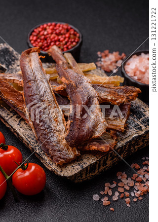 Dried salted fish as snacks or jerky, seafood as slices. Dried seafood snacks 131221722