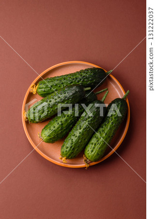 Fresh raw whole cucumbers, an ingredient for preparing salads and vegetarian dishes. Green fresh cucumbers Fresh raw whole cucumbers, an ingredient for preparing salads and vegetarian dishes. Green fresh cucumbers 131222037