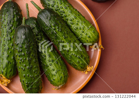 Fresh raw whole cucumbers, an ingredient for preparing salads and vegetarian dishes. Green fresh cucumbers 131222044