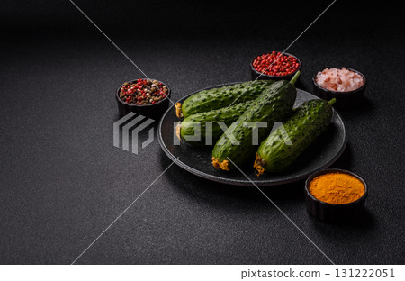 Fresh raw whole cucumbers, an ingredient for preparing salads and vegetarian dishes. Green fresh cucumbers 131222051