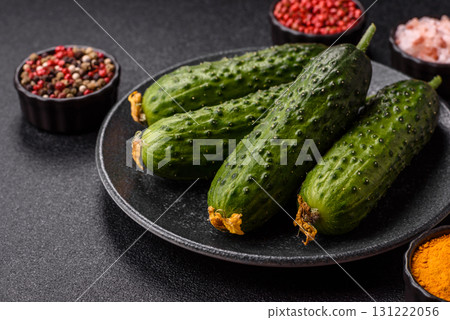 Fresh raw whole cucumbers, an ingredient for preparing salads and vegetarian dishes. Green fresh cucumbers Fresh raw whole cucumbers, an ingredient for preparing salads and vegetarian dishes. Green fresh cucumbers 131222056