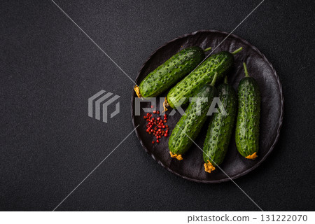 Fresh raw whole cucumbers, an ingredient for preparing salads and vegetarian dishes. Green fresh cucumbers Fresh raw whole cucumbers, an ingredient for preparing salads and vegetarian dishes. Green fresh cucumbers 131222070