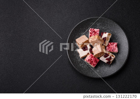 Nougat or white caramel with hazelnuts and pistachios and strawberry pieces. Nougat with nuts Nougat or white caramel with hazelnuts and pistachios and strawberry pieces. Nougat with nuts 131222170