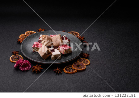 Nougat or white caramel with hazelnuts and pistachios and strawberry pieces. Nougat with nuts 131222181