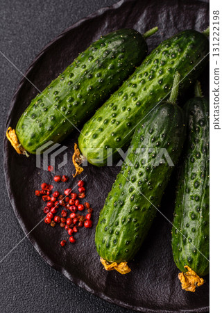 Fresh raw whole cucumbers, an ingredient for preparing salads and vegetarian dishes. Green fresh cucumbers Fresh raw whole cucumbers, an ingredient for preparing salads and vegetarian dishes. Green fresh cucumbers 131222198