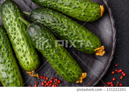 Fresh raw whole cucumbers, an ingredient for preparing salads and vegetarian dishes. Green fresh cucumbers Fresh raw whole cucumbers, an ingredient for preparing salads and vegetarian dishes. Green fresh cucumbers 131222201