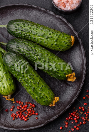 Fresh raw whole cucumbers, an ingredient for preparing salads and vegetarian dishes. Green fresh cucumbers 131222202