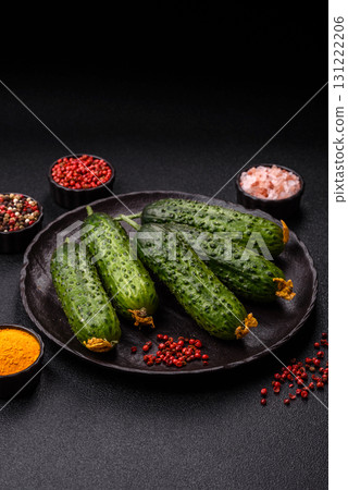 Fresh raw whole cucumbers, an ingredient for preparing salads and vegetarian dishes. Green fresh cucumbers Fresh raw whole cucumbers, an ingredient for preparing salads and vegetarian dishes. Green fresh cucumbers 131222206