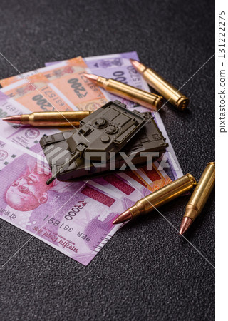 Money and flag of India with ammunition and tank as a concept of weapons for war. India and weapons Money and flag of India with ammunition and tank as a concept of weapons for war. India and weapons 131222275