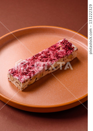 Nougat or white caramel with hazelnuts and strawberry pieces. White nougat Nougat or white caramel with hazelnuts and strawberry pieces. White nougat 131222329