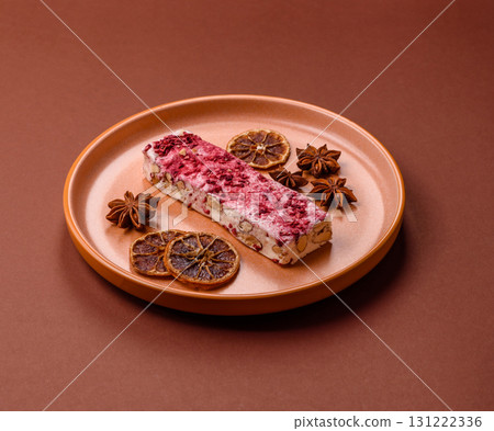 Nougat or white caramel with hazelnuts and strawberry pieces. White nougat Nougat or white caramel with hazelnuts and strawberry pieces. White nougat 131222336