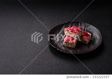 Nougat or white caramel with hazelnuts and strawberry pieces. White nougat Nougat or white caramel with hazelnuts and strawberry pieces. White nougat 131222337