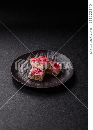 Nougat or white caramel with hazelnuts and strawberry pieces. White nougat Nougat or white caramel with hazelnuts and strawberry pieces. White nougat 131222340