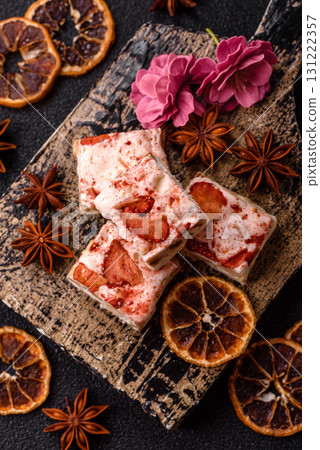 Nougat or white caramel with hazelnuts and strawberry pieces. White nougat Nougat or white caramel with hazelnuts and strawberry pieces. White nougat 131222357