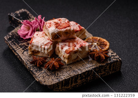 Nougat or white caramel with hazelnuts and strawberry pieces. White nougat Nougat or white caramel with hazelnuts and strawberry pieces. White nougat 131222359