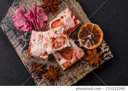 Nougat or white caramel with hazelnuts and strawberry pieces. White nougat Nougat or white caramel with hazelnuts and strawberry pieces. White nougat 131222360