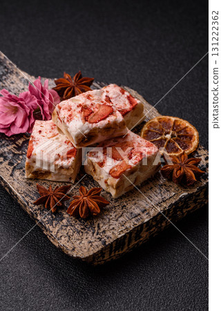 Nougat or white caramel with hazelnuts and strawberry pieces. White nougat 131222362
