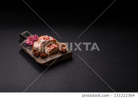 Nougat or white caramel with hazelnuts and strawberry pieces. White nougat Nougat or white caramel with hazelnuts and strawberry pieces. White nougat 131222364