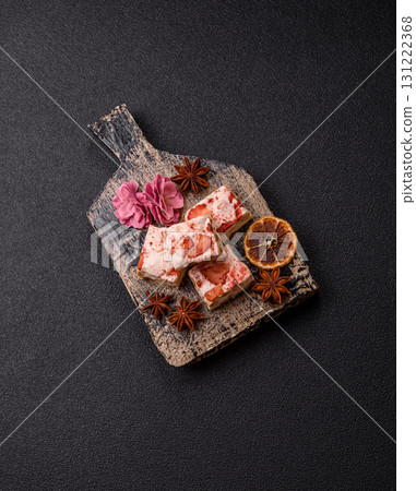 Nougat or white caramel with hazelnuts and strawberry pieces. White nougat 131222368