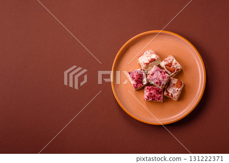 Nougat or white caramel with hazelnuts and strawberry pieces. White nougat 131222371
