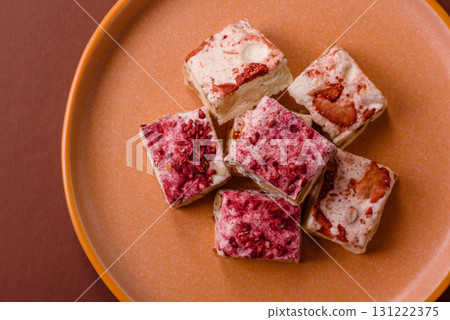 Nougat or white caramel with hazelnuts and strawberry pieces. White nougat Nougat or white caramel with hazelnuts and strawberry pieces. White nougat 131222375