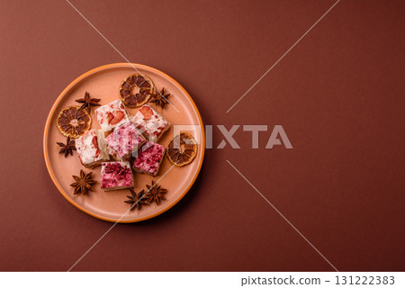 Nougat or white caramel with hazelnuts and strawberry pieces. White nougat 131222383