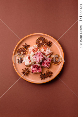Nougat or white caramel with hazelnuts and strawberry pieces. White nougat 131222384