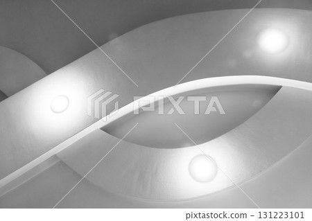A grayscale abstract architectural scene featuring curved surfaces and spot lights A grayscale abstract architectural scene featuring curved surfaces and spot lights 131223101