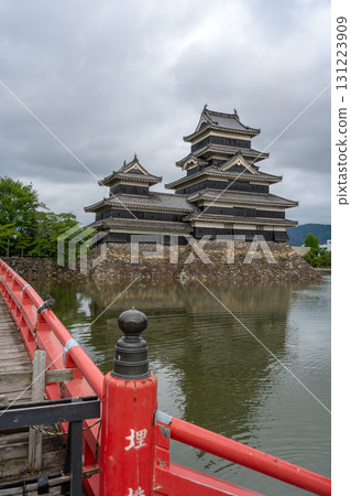 Red bridge leading to majestic Matsumoto Castle in Japan 131223909
