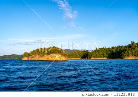 Sunset over Waleakodi Island, Togian archipelago, Sulawesi, Indonesia coastal landscape Sunset over Waleakodi Island, Togian archipelago, Sulawesi, Indonesia coastal landscape 131223918
