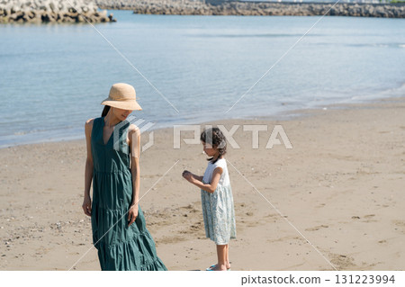 Families playing at the edge of the beach 131223994