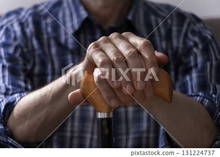 Middle age caucasian man hands holds cane closeup Middle age caucasian man hands holds cane closeup 131224737