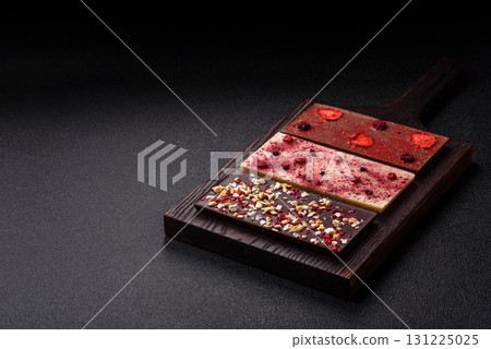 Bar sweet craft artisan chocolate with dried fruits made at home. Craft chocolate Bar sweet craft artisan chocolate with dried fruits made at home. Craft chocolate 131225025