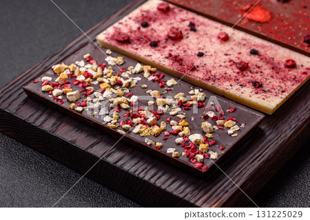 Bar sweet craft artisan chocolate with dried fruits made at home. Craft chocolate Bar sweet craft artisan chocolate with dried fruits made at home. Craft chocolate 131225029