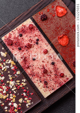 Bar sweet craft artisan chocolate with dried fruits made at home. Craft chocolate Bar sweet craft artisan chocolate with dried fruits made at home. Craft chocolate 131225031