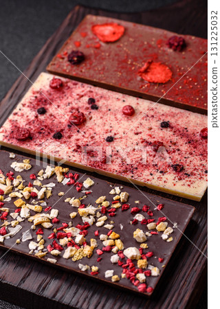 Bar sweet craft artisan chocolate with dried fruits made at home. Craft chocolate 131225032
