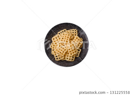 Lattice or wafer potato chips, crispy yellow snacks, takeaway food Lattice or wafer potato chips, crispy yellow snacks, takeaway food 131225558