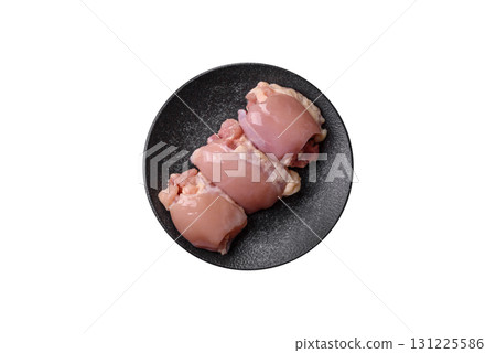 Raw chicken thigh fillet without skin and bone with salt and spices. Raw chicken fillet for cooking 131225586