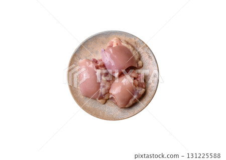 Raw chicken thigh fillet without skin and bone with salt and spices. Raw chicken fillet for cooking Raw chicken thigh fillet without skin and bone with salt and spices. Raw chicken fillet for cooking 131225588