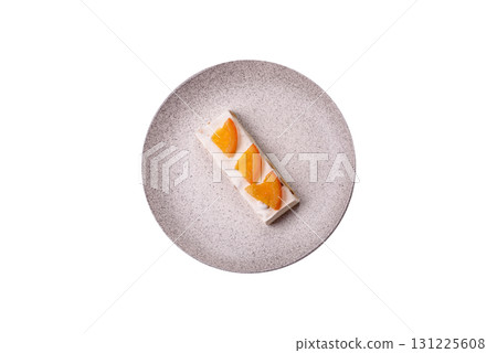 Nougat or white caramel with hazelnuts and pistachios and citrus pieces. White nougat with nuts 131225608