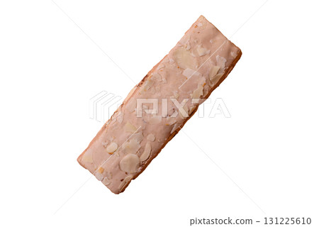 Nougat or white caramel with hazelnuts and pistachios and citrus pieces. White nougat with nuts 131225610