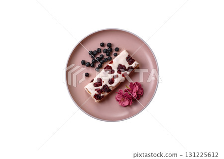 Nougat or white caramel with hazelnuts and pistachios and citrus pieces. White nougat with nuts 131225612