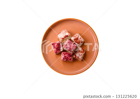 Nougat or white caramel with hazelnuts and strawberry pieces. White nougat 131225620