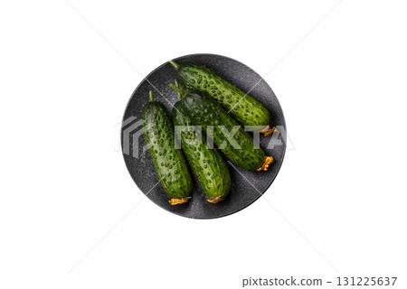 Fresh raw whole cucumbers, an ingredient for preparing salads and vegetarian dishes. Green fresh cucumbers Fresh raw whole cucumbers, an ingredient for preparing salads and vegetarian dishes. Green fresh cucumbers 131225637