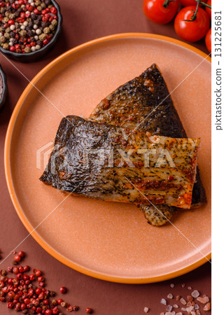 Food, seafood, grilled fish fillet with lemon, salt and spices. Grilled fish fillet Food, seafood, grilled fish fillet with lemon, salt and spices. Grilled fish fillet 131225681